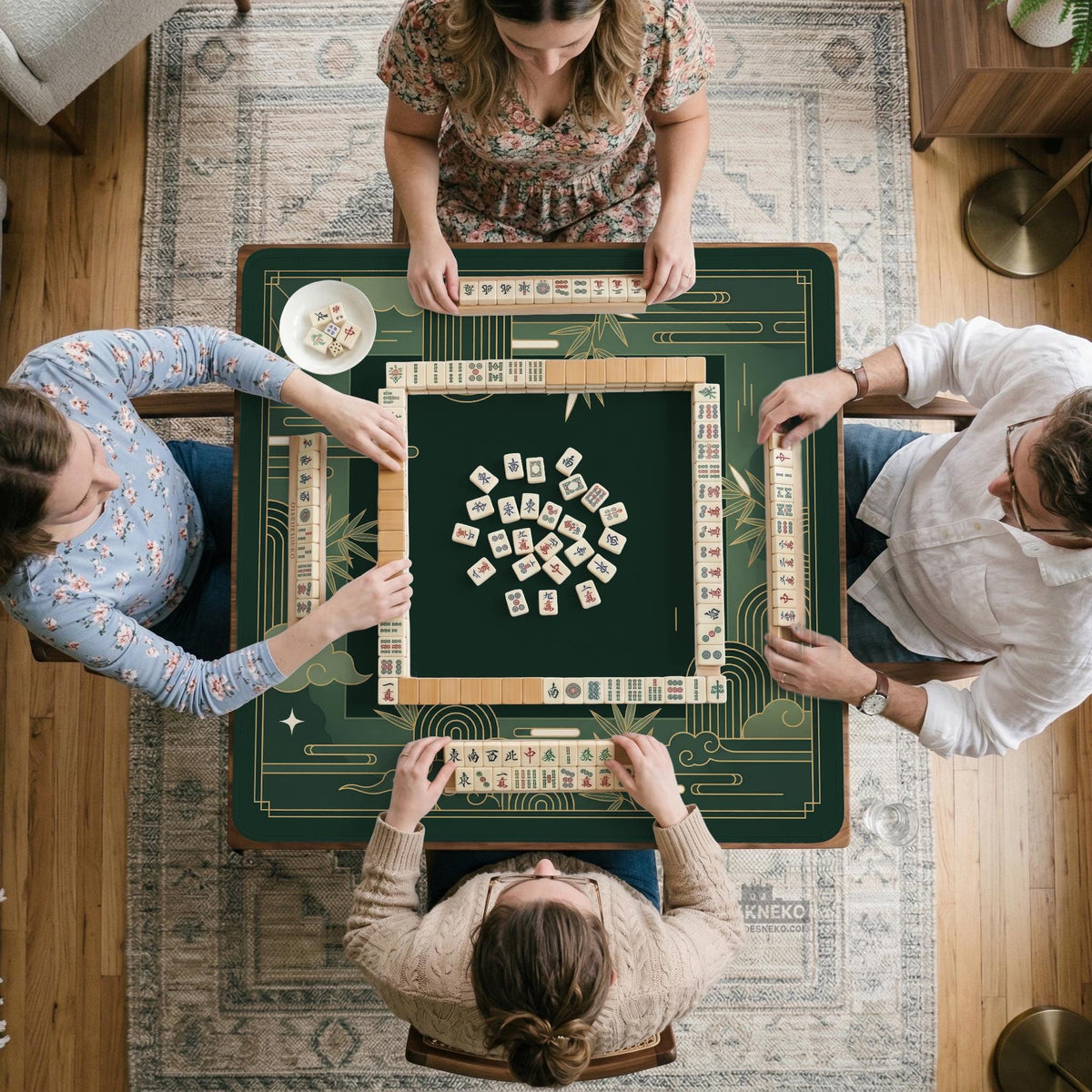 Square emerald green mahjong mat with bamboo line art, gold geometric cloud shapes, and a plain center playing area.
