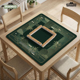 Square emerald green mahjong mat with bamboo line art, gold geometric cloud shapes, and a plain center playing area.
