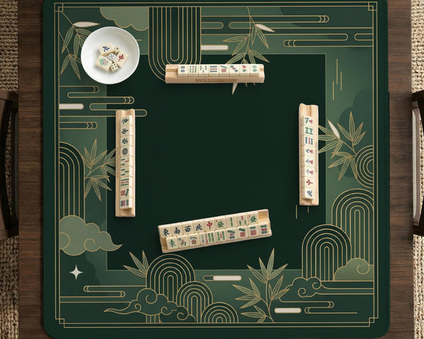 Square emerald green mahjong mat with bamboo line art, gold geometric cloud shapes, and a plain center playing area.