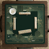Square emerald green mahjong mat with bamboo line art, gold geometric cloud shapes, and a plain center playing area.