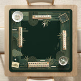 Square emerald green mahjong mat with bamboo line art, gold geometric cloud shapes, and a plain center playing area.