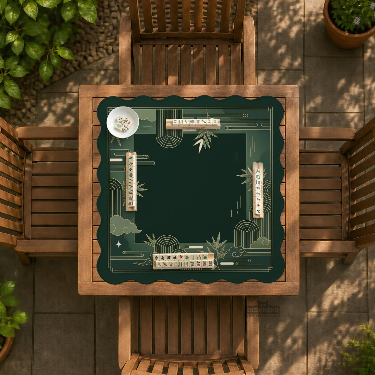 Square emerald green mahjong mat with bamboo line art, gold geometric cloud shapes, and a plain center playing area.