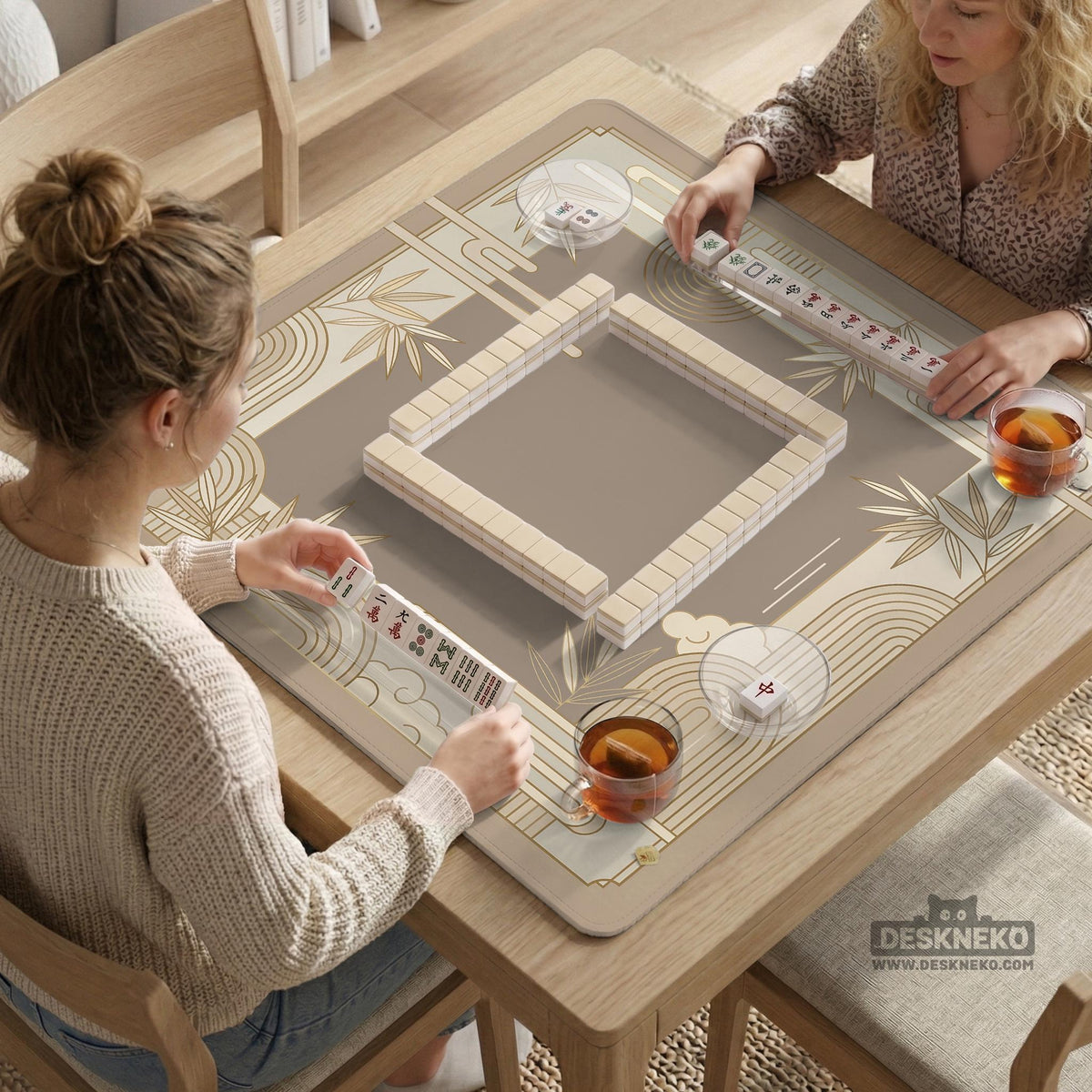 Beige and gold square mahjong mat with a bamboo pattern and geometric border.