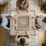 Beige and gold square mahjong mat with a bamboo pattern and geometric border.