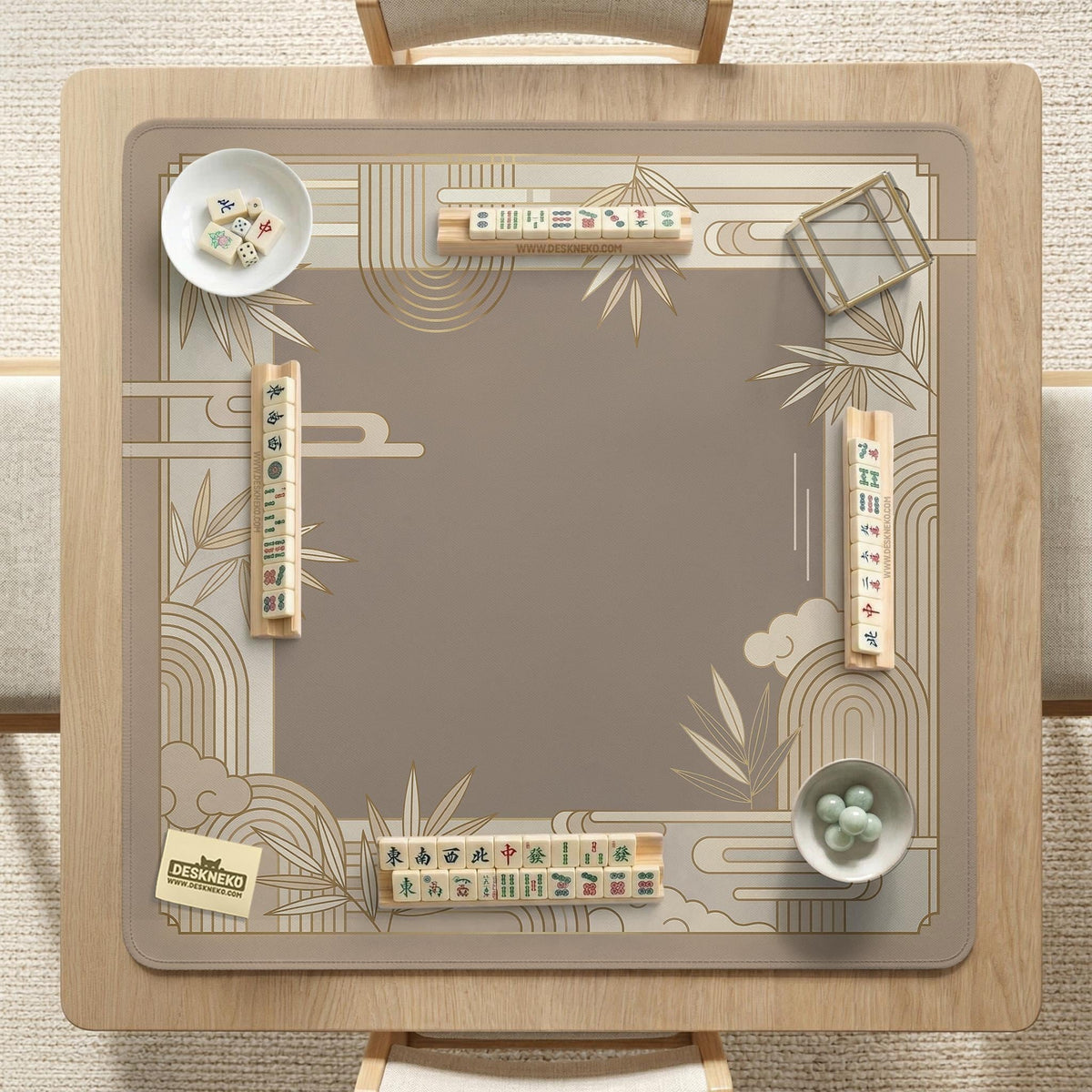 Beige and gold square mahjong mat with a bamboo pattern and geometric border.