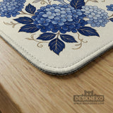 Blue and white mahjong table mat with a floral border, small birds, pagoda details, striped center, and printed rules around the edge.