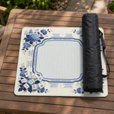 Blue and white mahjong table mat with a floral border, small birds, pagoda details, striped center, and printed rules around the edge.