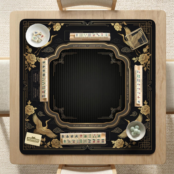 Black and gold square mahjong mat with an art deco crane and floral border, rule reminders around the edges, and a blank center area.