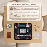 Burgundy mahjong mat with a floral border, gold botanical details, and printed American Mahjong rules on a dark background.