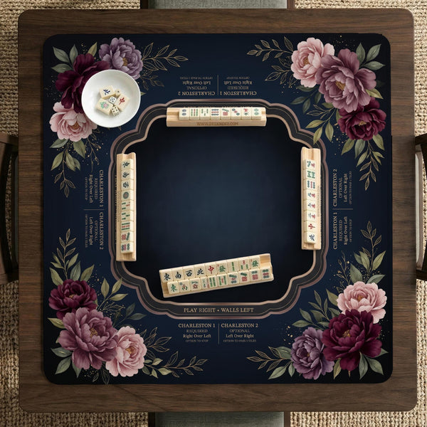 Burgundy mahjong mat with a floral border, gold botanical details, and printed American Mahjong rules on a dark background.