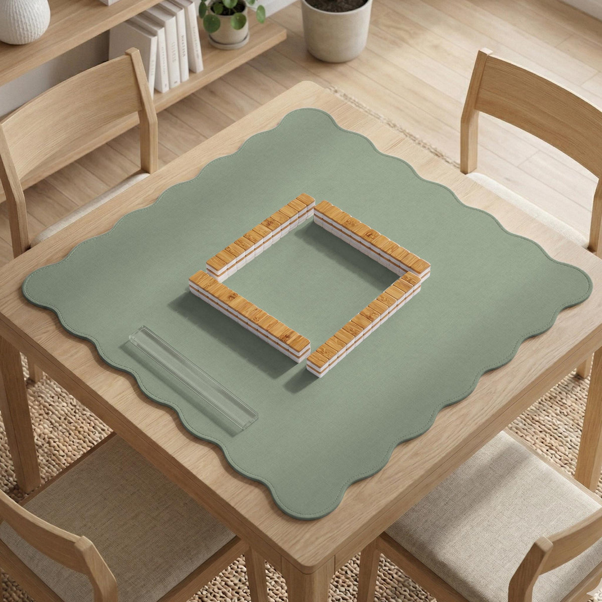 A square sage green mahjong mat with scalloped edges on a plain background.