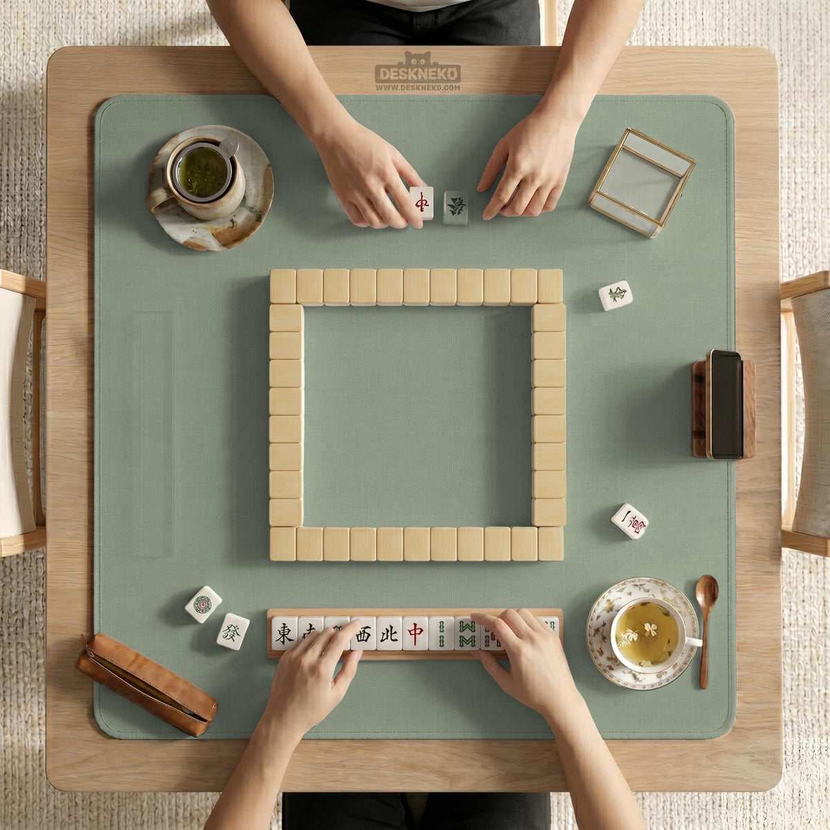 A square sage green mahjong mat with scalloped edges on a plain background.