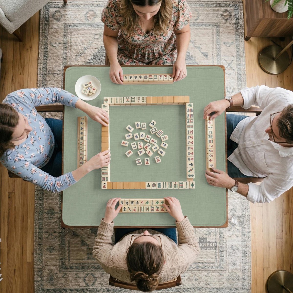 A square sage green mahjong mat with scalloped edges on a plain background.