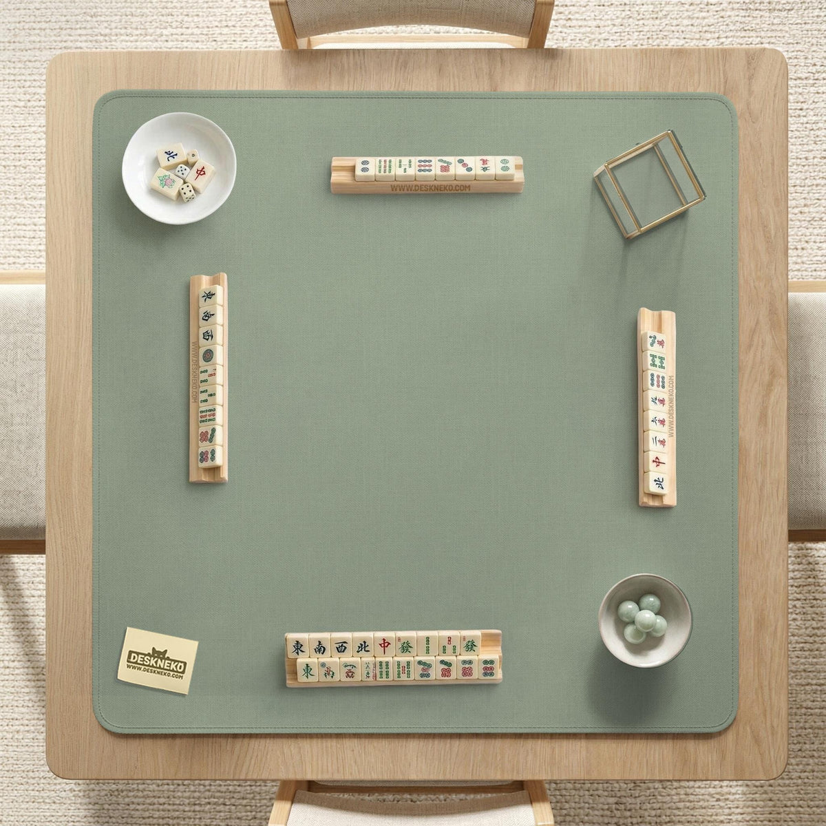 A square sage green mahjong mat with scalloped edges on a plain background.