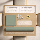 A square sage green mahjong mat with scalloped edges on a plain background.