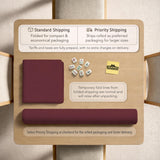 Plain burgundy square mahjong mat with scalloped edges on a white background.