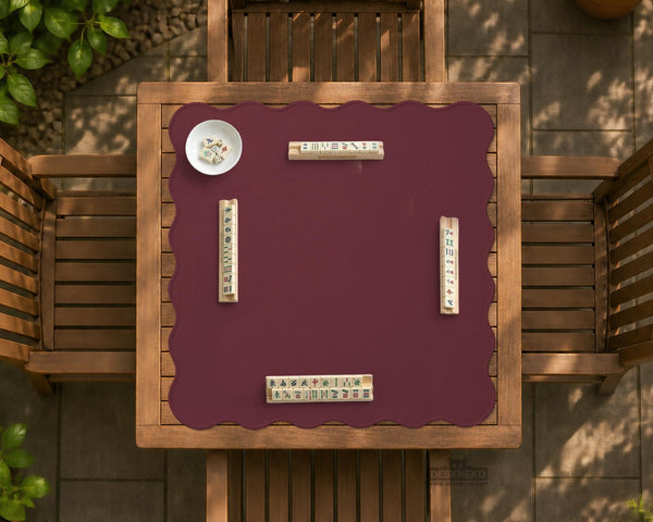 Plain burgundy square mahjong mat with scalloped edges on a white background.