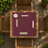 Plain burgundy square mahjong mat with scalloped edges on a white background.