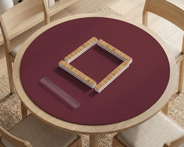 Plain burgundy square mahjong mat with scalloped edges on a white background.