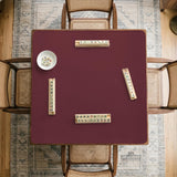 Plain burgundy square mahjong mat with scalloped edges on a white background.