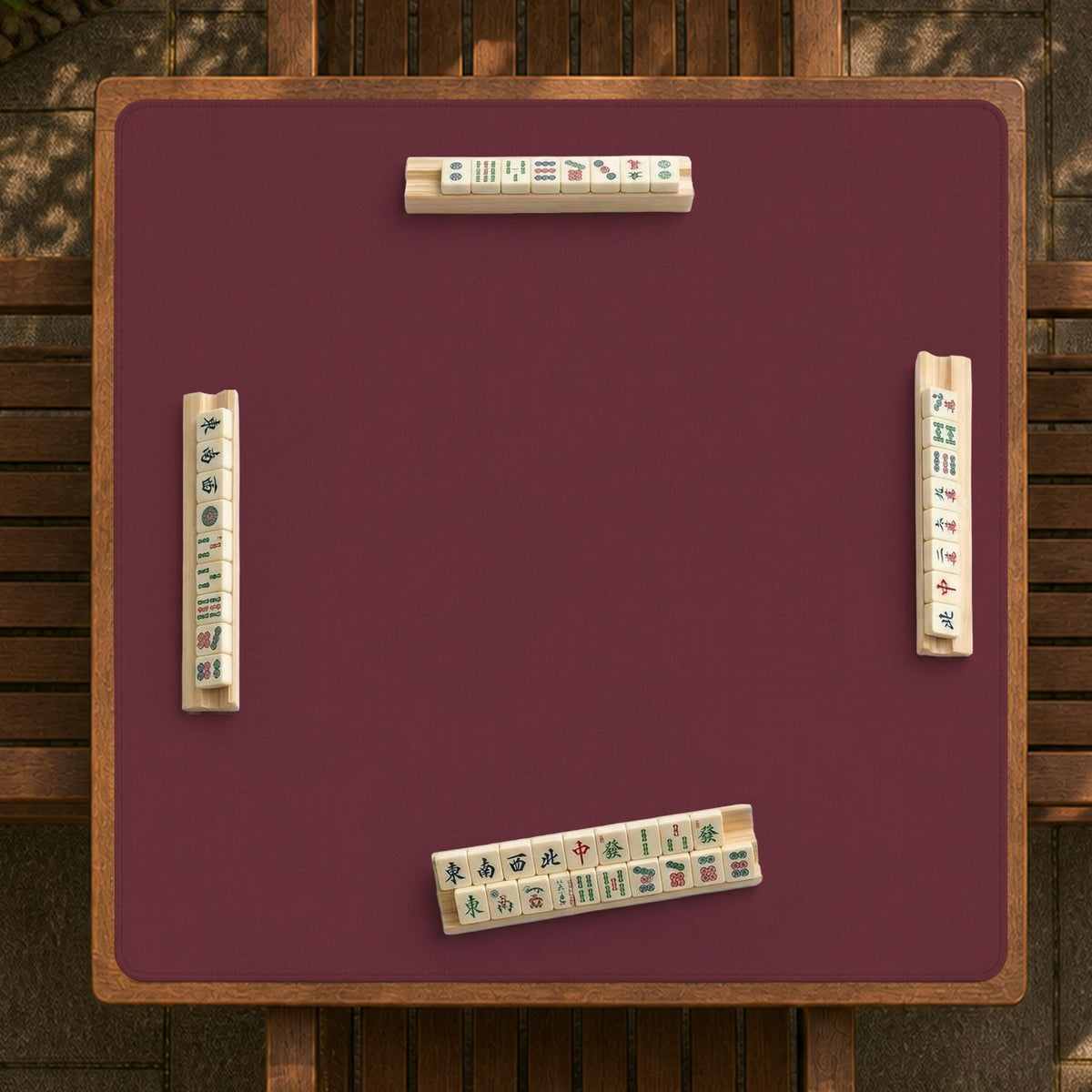 Plain burgundy square mahjong mat with scalloped edges on a white background.