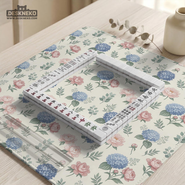 Pink floral mahjong table mat with peonies, blue hydrangeas, sage green leaves, and an ivory background.