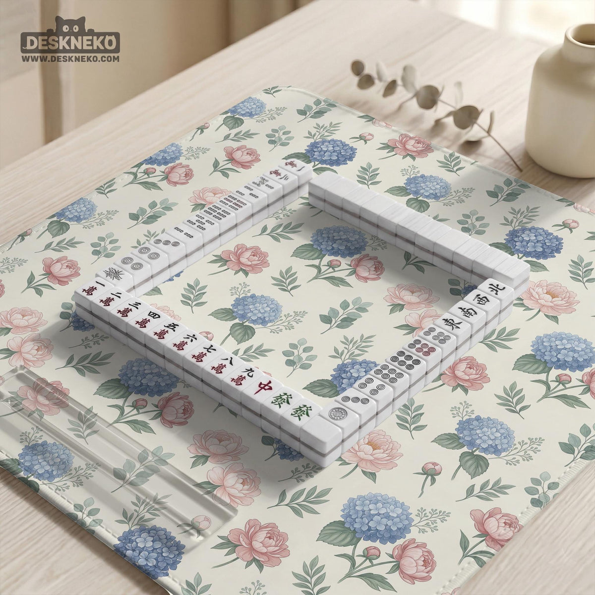 Pink floral mahjong table mat with peonies, blue hydrangeas, sage green leaves, and an ivory background.