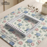 Pink floral mahjong table mat with peonies, blue hydrangeas, sage green leaves, and an ivory background.