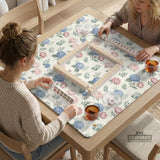 Pink floral mahjong table mat with peonies, blue hydrangeas, sage green leaves, and an ivory background.
