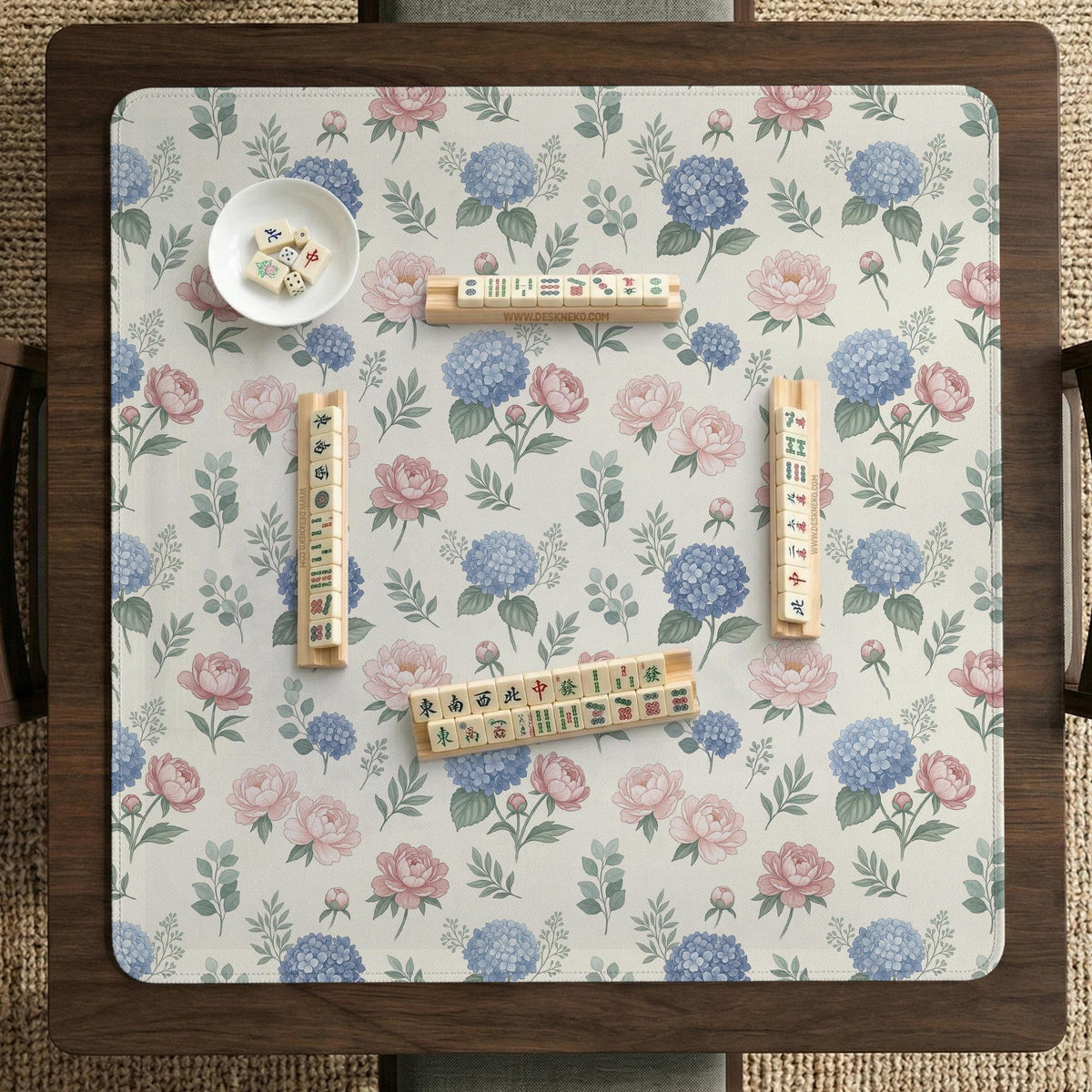 Pink floral mahjong table mat with peonies, blue hydrangeas, sage green leaves, and an ivory background.