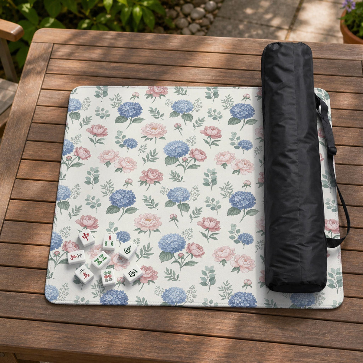 Pink floral mahjong table mat with peonies, blue hydrangeas, sage green leaves, and an ivory background.