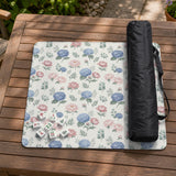 Pink floral mahjong table mat with peonies, blue hydrangeas, sage green leaves, and an ivory background.