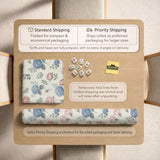 Pink floral mahjong table mat with peonies, blue hydrangeas, sage green leaves, and an ivory background.