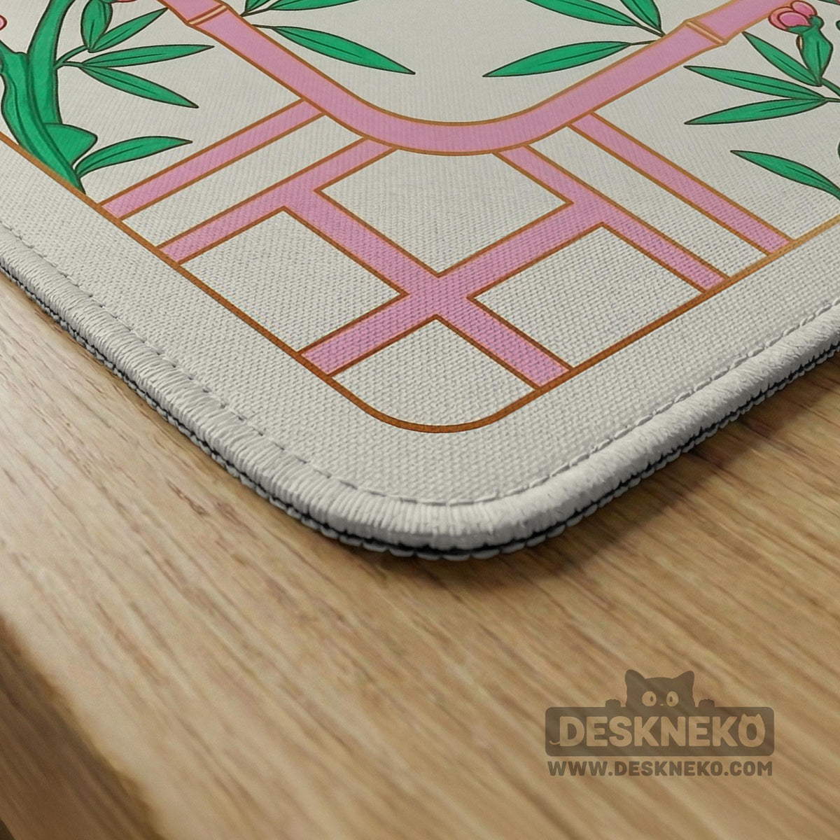 Pink cherry blossom floral mahjong table mat with a cream center and bamboo-style border design.