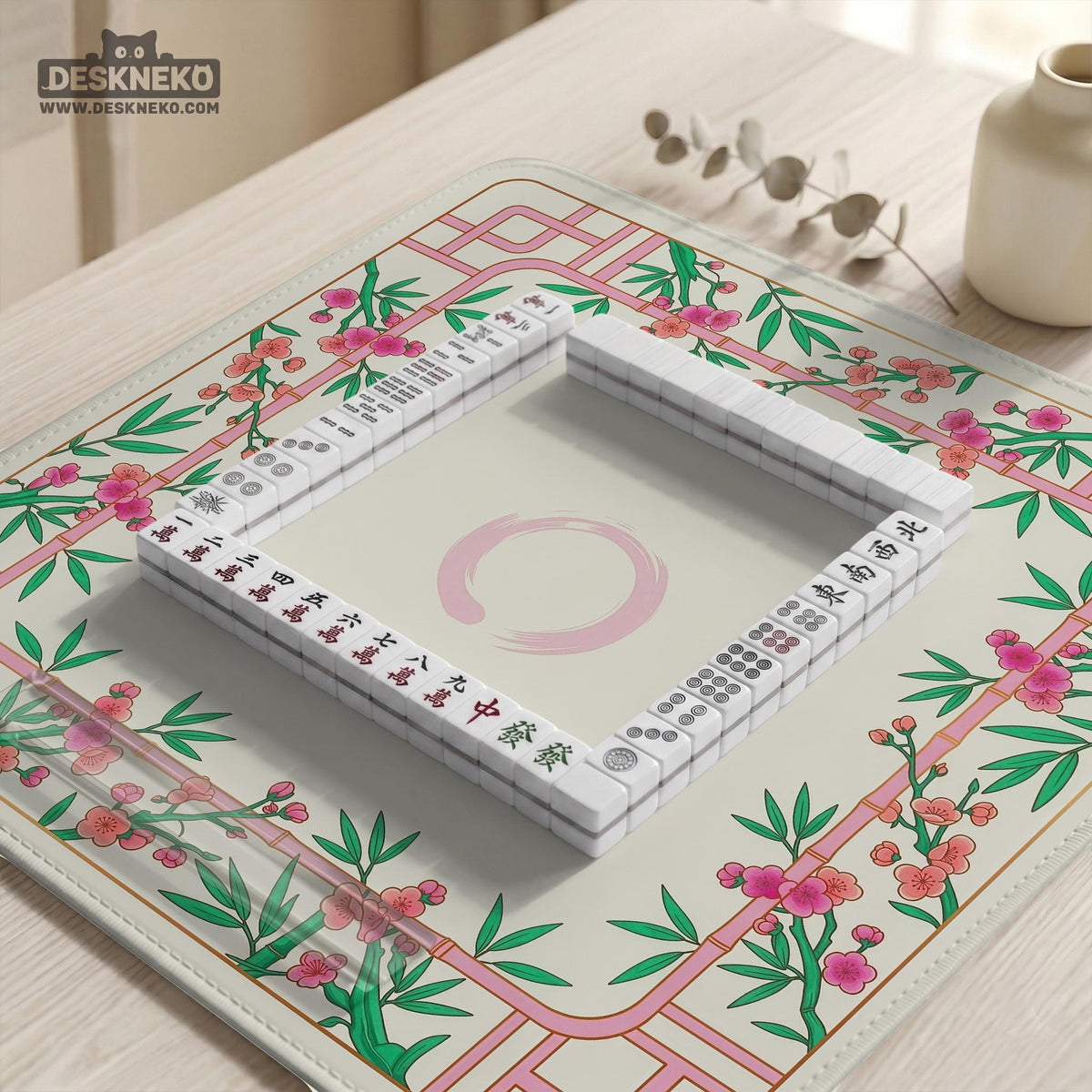 Pink cherry blossom floral mahjong table mat with a cream center and bamboo-style border design.