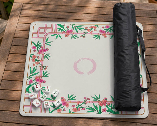 Pink cherry blossom floral mahjong table mat with a cream center and bamboo-style border design.