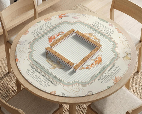Sage and cream mahjong mat with a koi fish pond pattern, lotus blooms, water ripples, and printed instructions around the border. One version has a scalloped edge.