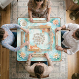 Pastel aqua square mahjong mat with orange koi fish, lotus flowers, lily pads, and flowing water lines.