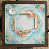 Pastel aqua square mahjong mat with orange koi fish, lotus flowers, lily pads, and flowing water lines.