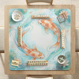 Pastel aqua square mahjong mat with orange koi fish, lotus flowers, lily pads, and flowing water lines.