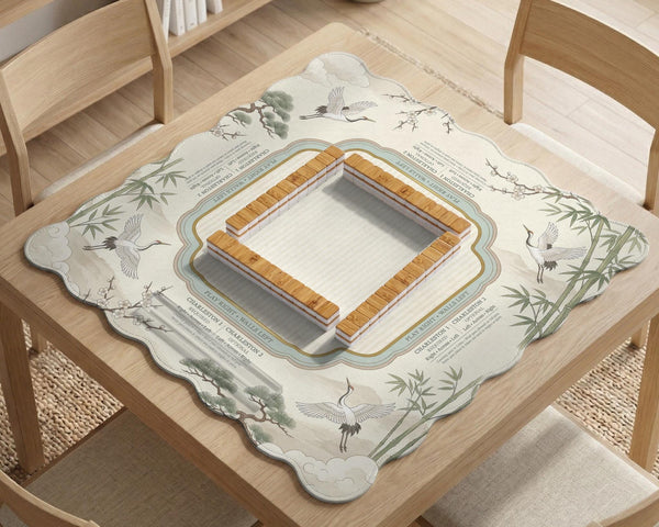 Sage green scalloped mahjong mat with bamboo, crane, and blossom illustration and printed rules around the border.