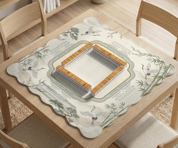 Sage green scalloped mahjong mat with bamboo, crane, and blossom illustration and printed rules around the border.