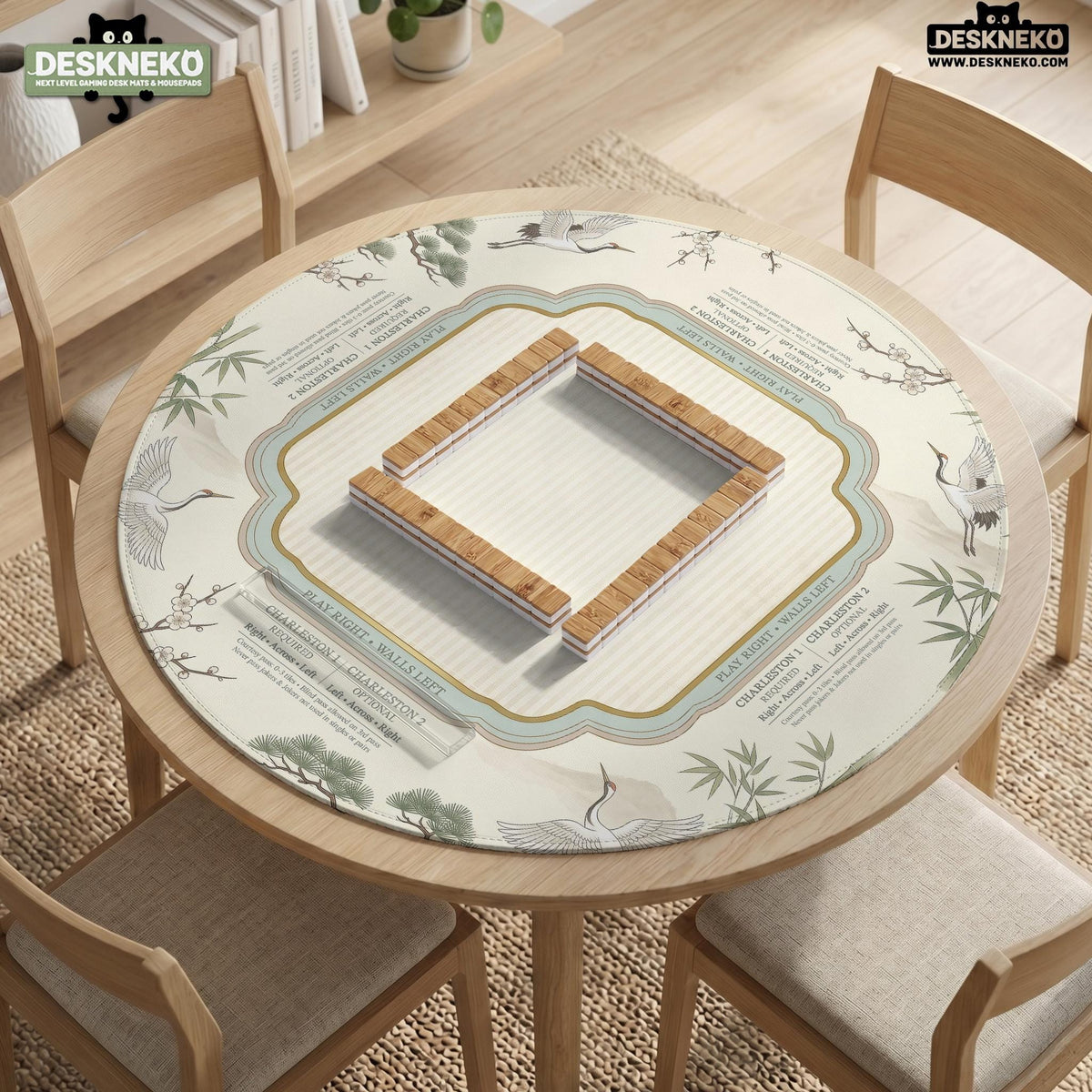 Sage green scalloped mahjong mat with bamboo, crane, and blossom illustration and printed rules around the border.