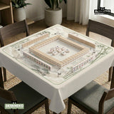 Sage green scalloped mahjong mat with bamboo, crane, and blossom illustration and printed rules around the border.