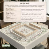 Sage green scalloped mahjong mat with bamboo, crane, and blossom illustration and printed rules around the border.