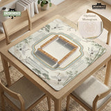Sage green scalloped mahjong mat with bamboo, crane, and blossom illustration and printed rules around the border.