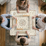 Cream mahjong mat with a floral pattern of small wildflowers and sage leaves, shown with a scalloped edge on a light neutral background.