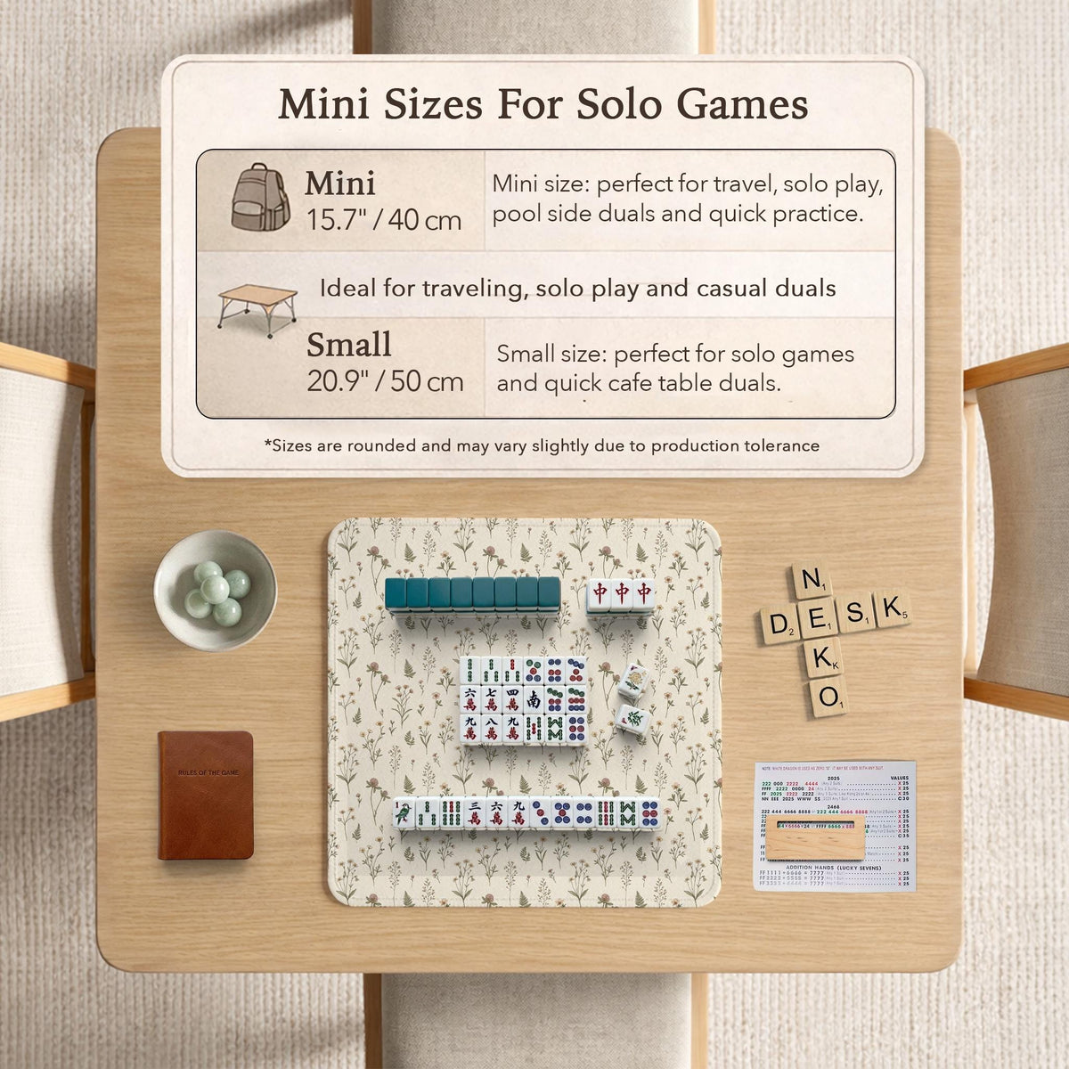 Cream mahjong mat with a floral pattern of small wildflowers and sage leaves, shown with a scalloped edge on a light neutral background.