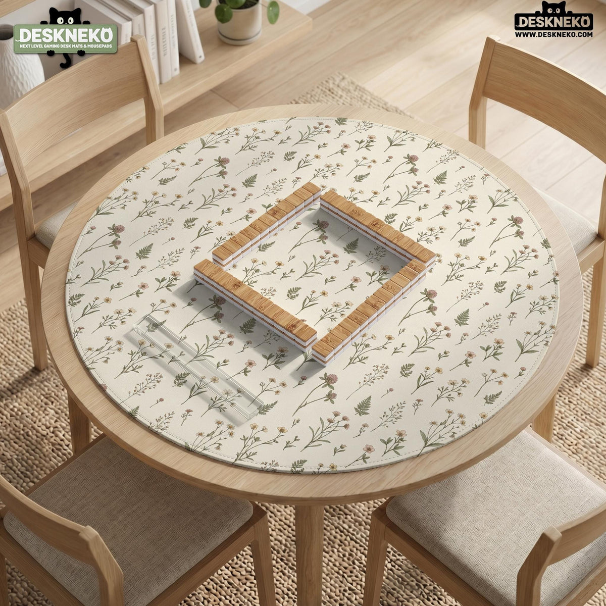 Cream mahjong mat with a floral pattern of small wildflowers and sage leaves, shown with a scalloped edge on a light neutral background.