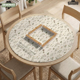 Cream mahjong mat with a floral pattern of small wildflowers and sage leaves, shown with a scalloped edge on a light neutral background.